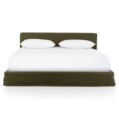 a bed with two pillows on top of it and white sheets in front of the headboard