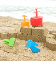 sand castle made out of bricks and plastic toys