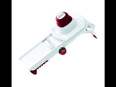 a red and white hand held stapler on a white background with clippings