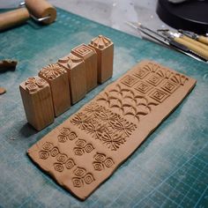 a wooden stamp sitting on top of a table next to some scissors and other crafting supplies