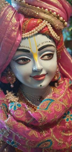 a close up of a person wearing a costume and headdress on their face