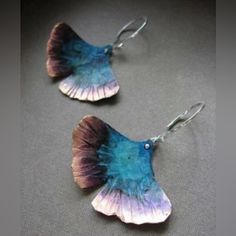 two pairs of earrings with blue and purple petals