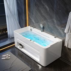 a bath tub with blue water inside of it