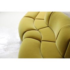 a yellow couch sitting on top of a white floor