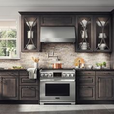 a kitchen with wooden cabinets and stainless steel appliances, including an electric stove top oven