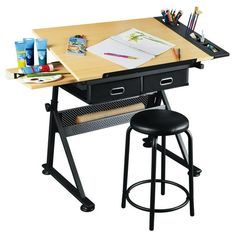 a desk with two stools and some art supplies on it