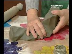 a person is making something out of clay