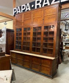 a large wooden cabinet sitting inside of a store