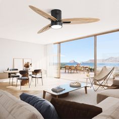 a living room filled with furniture and a ceiling fan