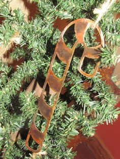 a close up of a tree with rusted metal decorations