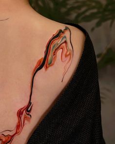 a woman with a tattoo on her shoulder