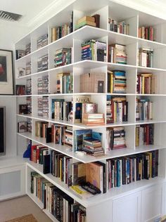 a white book shelf filled with lots of books