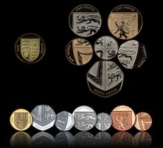 five different types of british coins on a black background with reflections in the foreground