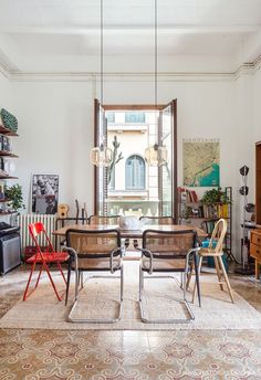 a dining room table and chairs in front of a window