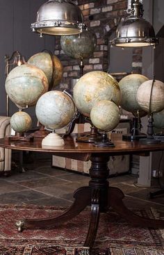 a table topped with lots of globes on top of it