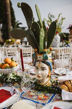 a table topped with a vase filled with plants