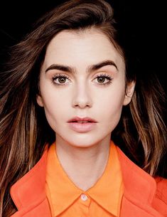 a woman with long hair and orange shirt