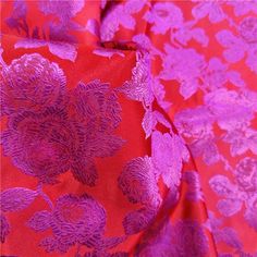 an image of red and purple fabric with flowers on it