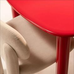 a red table and chair sitting next to each other