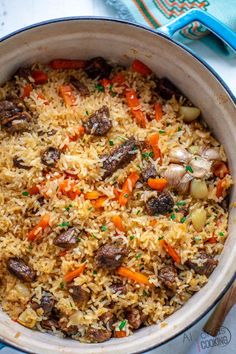 a pot filled with rice and vegetables on top of a table