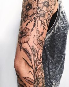 a man's arm with flowers on it