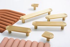 a group of wooden benches sitting next to each other on top of a white surface