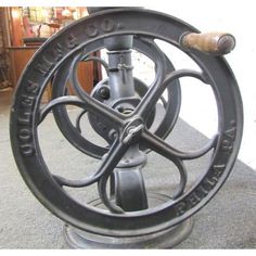 an old cast iron wheel on display in a store