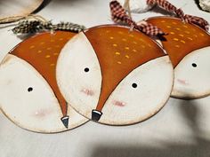 three wooden foxes are sitting on a table