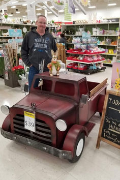 a man standing next to a toy truck in a store