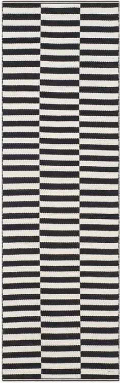 a black and white rug with vertical stripes