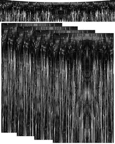 black and white photograph of rain falling down the side of a building with trees on it