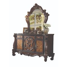 an ornate wooden dresser with mirror on top