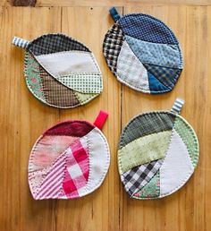 four pieces of fabric hanging on a wooden surface