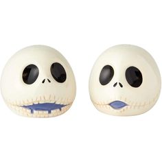 two white ceramic skulls with black eyes