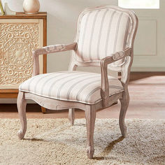 The Celeste Upholstered Camel Back Chair celebrates an understated vintage-style charm. Handcarved with ornate detailing, the wood chair features a reclaimed gray-washed finish that complements the neutral polyester upholstery.