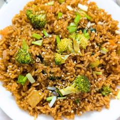 a white plate topped with rice and broccoli