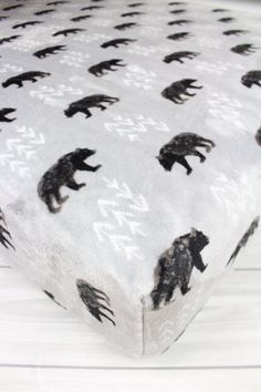 a black bear print on a white sheet