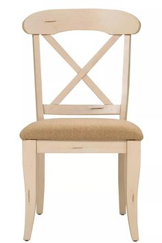 a white wooden chair with a tan seat