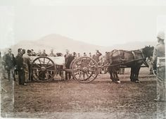 an old photo of people standing around horses and wagons