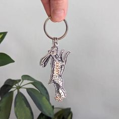 a person is holding onto a keychain with an animal on it's side