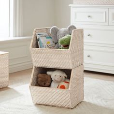 a basket filled with stuffed animals on top of a white floor next to a dresser