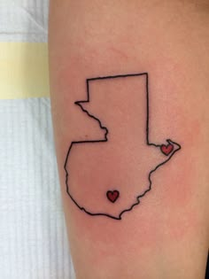 a small tattoo on the leg of a person with a heart in the shape of a state