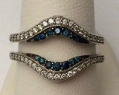 two wedding rings with blue and white stones on top of each other's bands