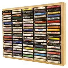 a wooden display case filled with lots of different types of dvd's and video tapes