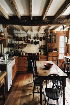 Picturesque rustic kitchen with hanging pots and an inviting dining area. Witchy Kitchen, Kitchen Design Decor