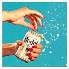 two hands reaching for a can of model beer in the air with bubbles coming out of it