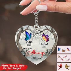 a heart shaped keychain with two butterflies on it and the words, dad, we are always with you