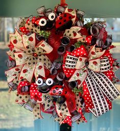 a red and white wreath with ladybugs, polka dots and eyeballs on it