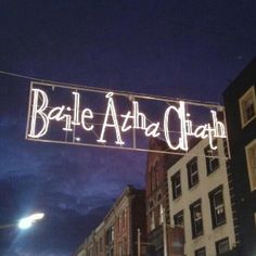 a sign that says baale aha ghaah hanging from the side of a building