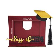 a graduation cap and tassel on top of a red box